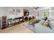 Bright living room with wood flooring, a brick fireplace, and comfortable seating at 6 Weathergreen Ct, Durham, NC 27713