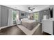 Spacious main bedroom with plush bed, hardwood floors, natural light, and tasteful decor at 6 Weathergreen Ct, Durham, NC 27713