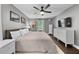 Serene main bedroom with king bed, neutral walls, and ample natural light from the windows at 6 Weathergreen Ct, Durham, NC 27713