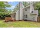 Exterior backyard view featuring deck, fenced yard, and well-maintained lawn at 6004 Volant Dr, Raleigh, NC 27609