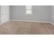 Bedroom featuring neutral walls and carpet, one window and white trim at 6004 Volant Dr, Raleigh, NC 27609