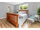 Bedroom with hardwood floors, a wood-frame bed, natural light, and decor at 6004 Volant Dr, Raleigh, NC 27609
