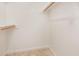 Bright walk-in closet with neutral paint, wood racks and tiled floor at 6004 Volant Dr, Raleigh, NC 27609