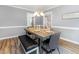 Comfortable dining area featuring a long, dark wood table with seating and a modern chandelier at 6004 Volant Dr, Raleigh, NC 27609