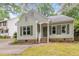 Charming home featuring a well-maintained yard and inviting front porch at 6004 Volant Dr, Raleigh, NC 27609