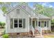 Charming home featuring a well-maintained yard and inviting front porch at 6004 Volant Dr, Raleigh, NC 27609