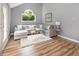 Cozy living room with vaulted ceilings, large windows, and comfortable sectional sofa at 6004 Volant Dr, Raleigh, NC 27609