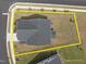 A home's roof and lawn are outlined in yellow to represent property lines on a sunny day at 601 Lauren Ann Dr, Apex, NC 27523