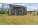 Two-story home featuring a well-maintained backyard and a dark gray exterior, offering a serene outdoor space at 601 Lauren Ann Dr, Apex, NC 27523