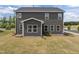 Spacious backyard showcasing a two-story home with dark gray siding and a well-maintained yard at 601 Lauren Ann Dr, Apex, NC 27523
