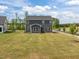 View of a two-story house with a well-manicured green yard and gray exterior siding, perfect for outdoor enjoyment at 601 Lauren Ann Dr, Apex, NC 27523