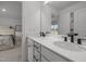 Bright bathroom featuring dual vanity with stone countertops and modern black fixtures at 601 Lauren Ann Dr, Apex, NC 27523