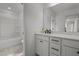 Bright bathroom featuring modern vanity with stone countertop and a shower-tub combination at 601 Lauren Ann Dr, Apex, NC 27523
