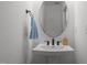 Elegant half bathroom featuring modern fixtures, a pedestal sink, and a sleek design at 601 Lauren Ann Dr, Apex, NC 27523