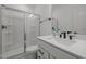 Bathroom features a modern vanity with solid surface countertop and walk-in shower with glass enclosure at 601 Lauren Ann Dr, Apex, NC 27523