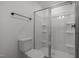 Bright bathroom featuring glass enclosed shower, sleek fixtures, and modern toilet at 601 Lauren Ann Dr, Apex, NC 27523