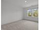 Bright and airy bedroom featuring two large windows and neutral walls and flooring at 601 Lauren Ann Dr, Apex, NC 27523