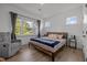 Bright bedroom with a large window, hardwood floors, neutral walls, and comfortable furniture at 601 Lauren Ann Dr, Apex, NC 27523