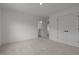 Neutral bedroom boasting plush carpet, crisp white trim, and convenient access to bathroom at 601 Lauren Ann Dr, Apex, NC 27523
