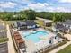 Aerial view of a community pool and clubhouse, surrounded by well-manicured landscaping and parking at 601 Lauren Ann Dr, Apex, NC 27523