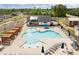 Aerial view of a community pool area with lounge chairs and umbrellas on a sunny day at 601 Lauren Ann Dr, Apex, NC 27523