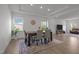Dining area with a modern chandelier, decorative rug, and is open to the living area at 601 Lauren Ann Dr, Apex, NC 27523