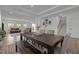 Spacious dining area next to open staircase and living area, featuring a large table and bench seating at 601 Lauren Ann Dr, Apex, NC 27523