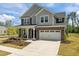 Charming two-story home with brick and siding, manicured lawn, and attached two car garage at 601 Lauren Ann Dr, Apex, NC 27523