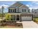 Charming two-story home featuring a brick and siding facade, and a two-car garage at 601 Lauren Ann Dr, Apex, NC 27523