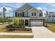 Charming two-story home with brick and siding, manicured lawn, and attached two car garage at 601 Lauren Ann Dr, Apex, NC 27523