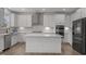 Modern kitchen featuring stainless appliances, quartz countertops, and a kitchen island at 601 Lauren Ann Dr, Apex, NC 27523