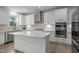 Modern kitchen showcasing white cabinets, stainless steel appliances, and a functional center island at 601 Lauren Ann Dr, Apex, NC 27523