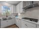Close-up of a well-equipped kitchen featuring stainless steel appliances and modern backsplash at 601 Lauren Ann Dr, Apex, NC 27523