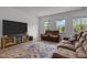 Living room has a modern TV, and comfortable reclining chairs with open layout to dining area at 601 Lauren Ann Dr, Apex, NC 27523