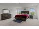 Comfortable main bedroom featuring a stylish wood bed frame, dresser, and bright windows at 601 Lauren Ann Dr, Apex, NC 27523