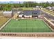 Aerial view showcasing a community tennis court next to a clubhouse and other community ammenities at 601 Lauren Ann Dr, Apex, NC 27523