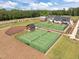 An aerial view of tennis courts and a covered area in a residential neighborhood on a sunny day at 601 Lauren Ann Dr, Apex, NC 27523