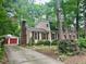 Inviting two-story house with red shutters, well-maintained landscaping and a detached garage at 702 Longleaf Dr, Chapel Hill, NC 27517