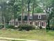 Attractive two-story house showcasing classic shutters and mature trees in a serene neighborhood at 702 Longleaf Dr, Chapel Hill, NC 27517