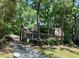 Charming two-story home featuring red shutters, lush landscaping and a detached garage at 702 Longleaf Dr, Chapel Hill, NC 27517