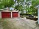 Detached two-car garage with red doors and a basketball hoop at 702 Longleaf Dr, Chapel Hill, NC 27517
