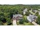 Desirable brick home in a lush setting with mature trees, showcasing its beautiful landscaping and curb appeal at 708 Cheselden Dr, Durham, NC 27713