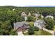 Stunning aerial view of a brick home surrounded by lush greenery, showcasing its desirable neighborhood setting at 708 Cheselden Dr, Durham, NC 27713