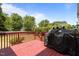Outdoor deck with a grill and wooded views, perfect for grilling and outdoor entertaining at 708 Cheselden Dr, Durham, NC 27713