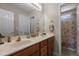 Double vanity bathroom featuring wood cabinets, a large mirror, and a shower and bathtub at 708 Cheselden Dr, Durham, NC 27713
