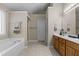 Spacious bathroom with a large soaking tub, separate shower, and wood cabinets at 708 Cheselden Dr, Durham, NC 27713
