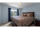 Bedroom featuring a beautiful bed, carpet floor, a window that provides natural light, and brown walls at 708 Cheselden Dr, Durham, NC 27713