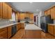 Well-lit kitchen featuring wood cabinets, stainless steel appliances, a center island, and hardwood floors at 708 Cheselden Dr, Durham, NC 27713