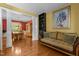 Elegant living room with hardwood floors, decorative columns, and dining room in view at 708 Cheselden Dr, Durham, NC 27713