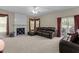 Spacious living room featuring a fireplace, brown leather furniture, and sliding glass doors to the outside patio at 708 Cheselden Dr, Durham, NC 27713